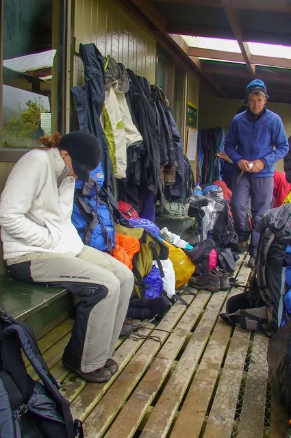Lots of hikers diving for cover in the hut
