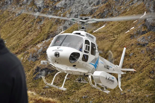 On time, our helicopter transport arrives to take us over the Harris Saddle