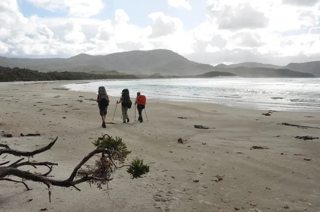 The gang heads off along the beach at Cox Bight