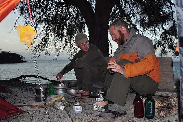 The boys cooking up the fresh fish supper on the 2-stove wild kitchen