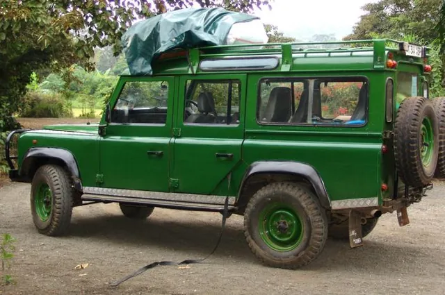 An immaculate green Land Rover arrives early to collect us