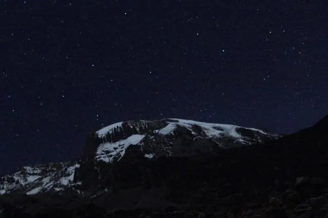 Kilimanjaro's glaciers glow a brilliant white in the moonlit night