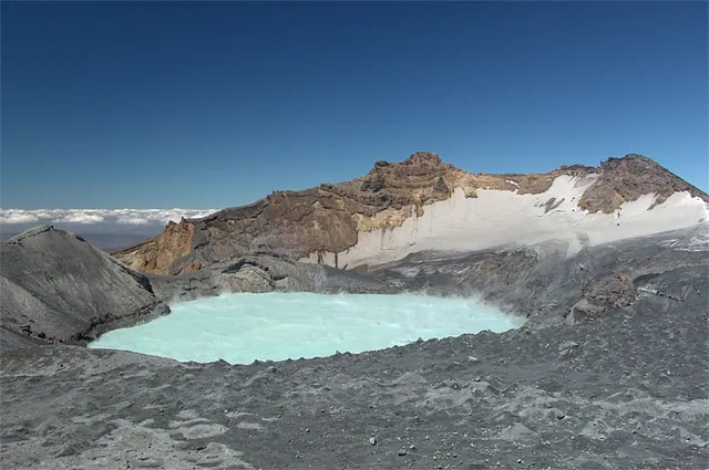 Reaching the top with relative ease, we are treated to a view of this cyan coloured crater lake