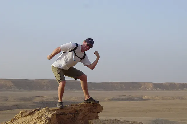 Strong man pose on the top