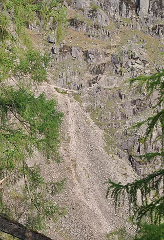 A narrow path that climbs up from the Seathwaite camp site