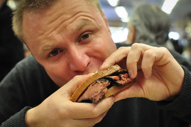 Neil getting to work on the signature pastrami sandwich