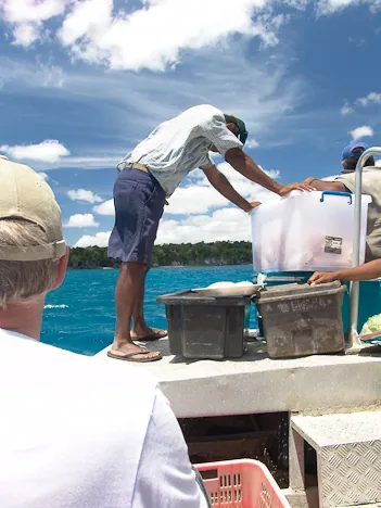 We arrive in Sun and Moon Bay and travel to the beach on the tender boat. Our BBQ lunch up front with everybody ravenous looking at it