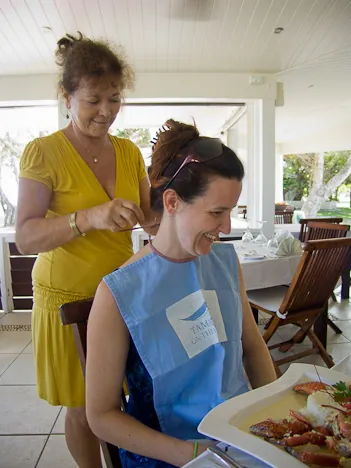 Gill (mucky pup that she is) gets a bib before tucking into her Coconut Crab dish