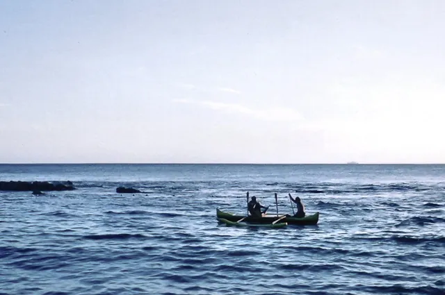 Couple of fellows cruising around in their traditional craft
