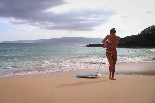 Having a go at boogie boarding on one of the western beaches