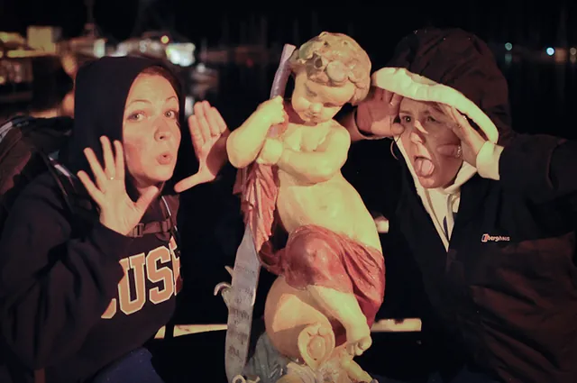 The girls take drunken exception to the creepy statue in Tobermory