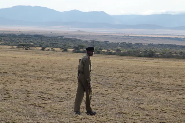 For our morning walkabout into Olduvai Gorge, we're accompanied by an armed guard