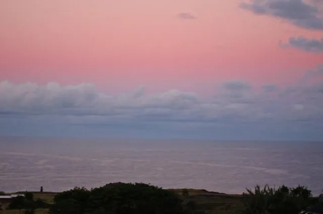 Sunrise (and a little Moai) over the coast.
