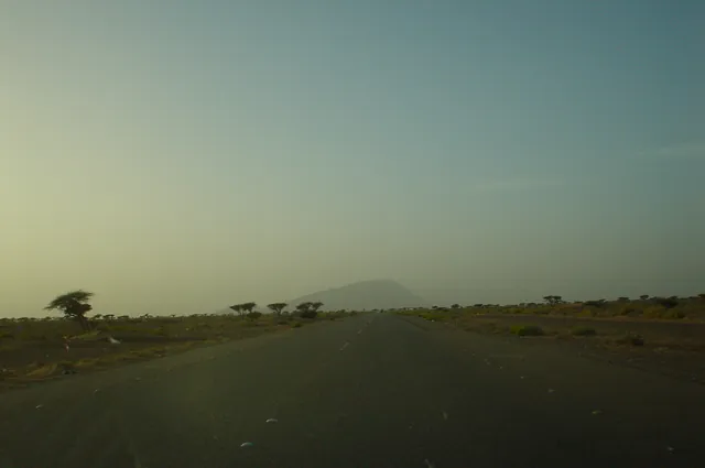Driving back to Dubai, UAE's highest mountain Jebel Hafeet sits on the horizon