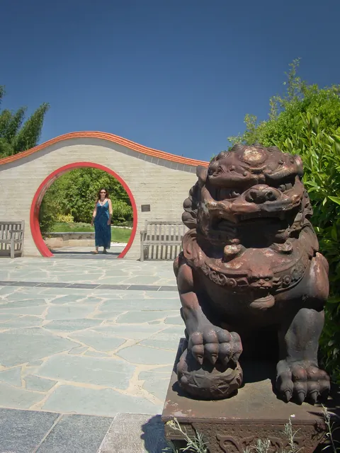 A rotund statue guarding the Chinese Moongate