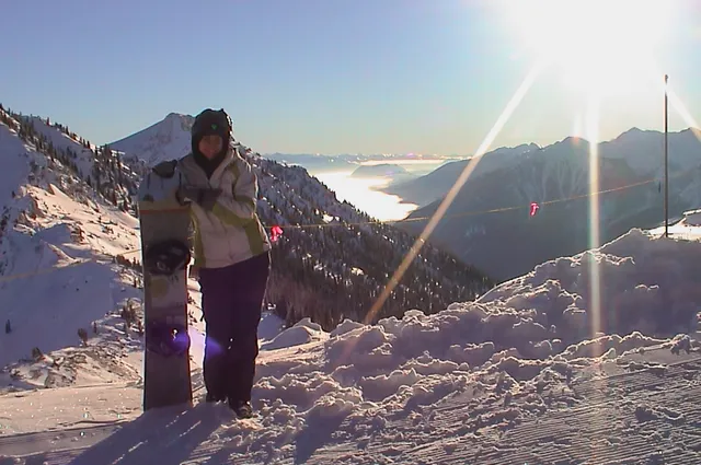 Gill at the top with one heck of a mountain vista to accompany the board down
