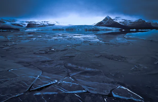A dark view of the neighbouring Fjallsjokull glacier lagoon