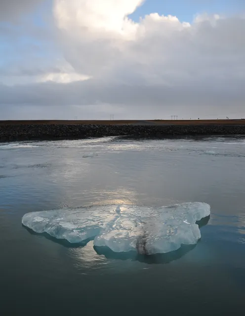 Fortunate timing with a small 'berg floating past and the sun breaking through and shining down on it
