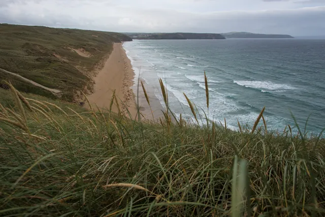 Looking down the long Perran Beach section, with the curious figure standing in the middle of the beach