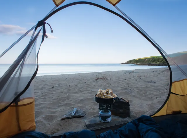 A hot dog dinner on the deserted Porthbean Beach