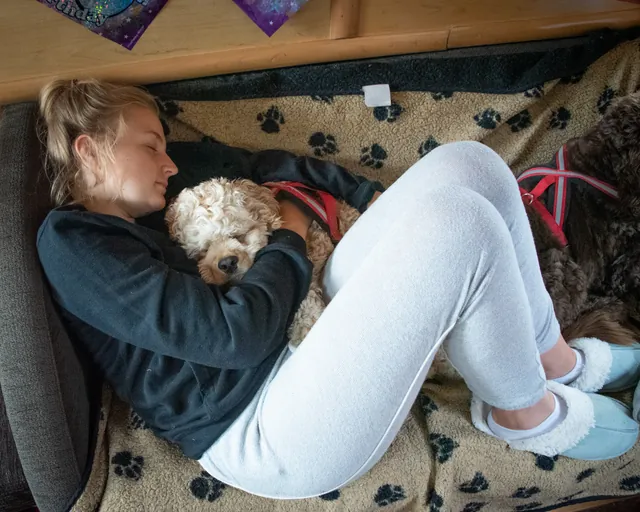 Amy having cuddles with Betty on the sofa