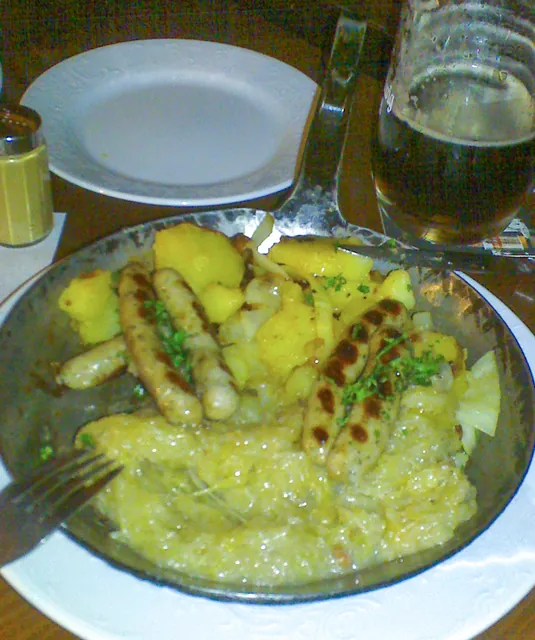 A hearty German meal of sausages, sauerkraut, potatoes and onion