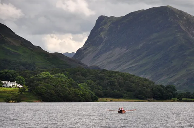 A solitary rowboat with the imposing Fleetwith Pike behind