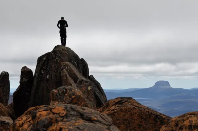 Jake standing tall on the summit rock