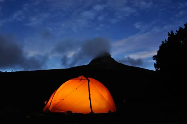 Our new Exped tent lit up beneath Barn Bluff - everybody hits the hay early after a successful first day
