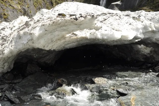 The water exited from a snow cave and the wind coming out was ice cold