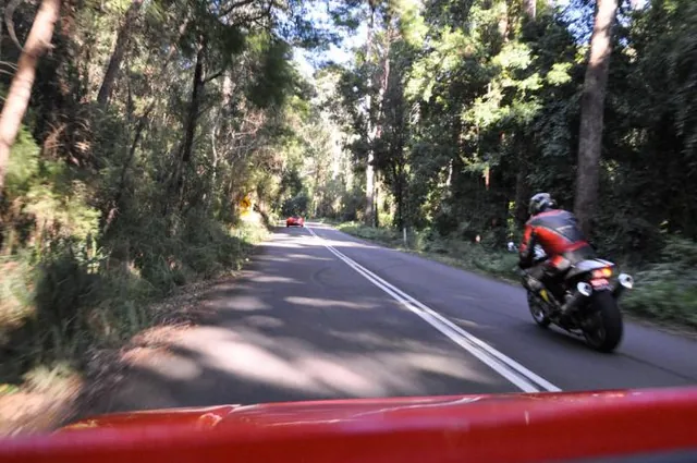 Ferraris dual with motorbikes along the meandering National Park roads